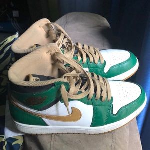 A pair of Green and white Jordan’s size 9.5